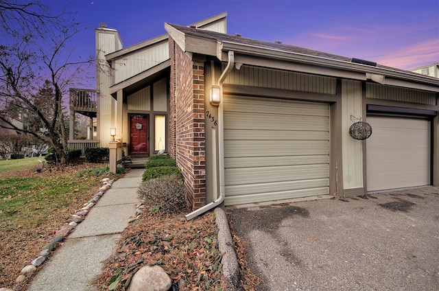 ranch-style home with a balcony and a garage