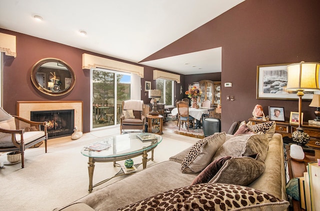 living room featuring lofted ceiling, light colored carpet, and a wall mounted air conditioner