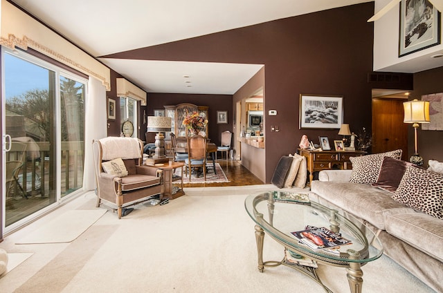 carpeted living room with lofted ceiling