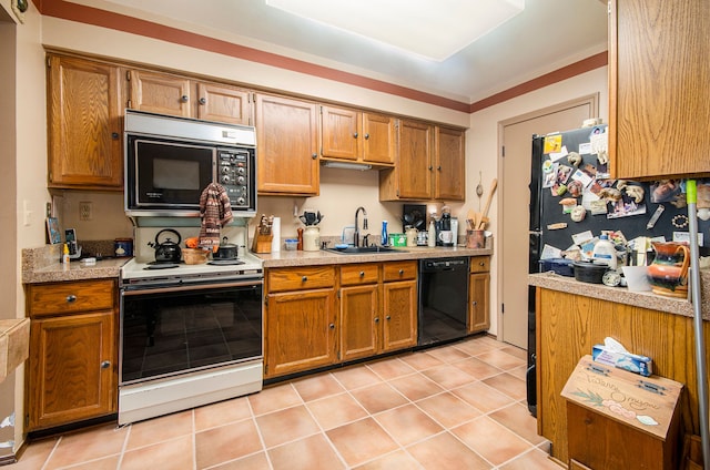 kitchen with sink, light tile patterned floors, and black appliances