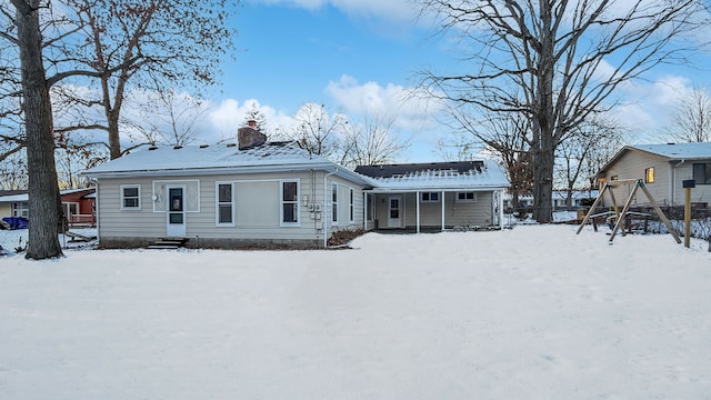 view of snow covered rear of property