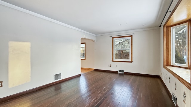 unfurnished room with dark hardwood / wood-style flooring and ornamental molding