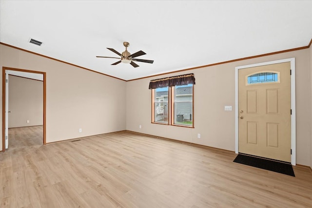 foyer entrance with light hardwood / wood-style floors, ceiling fan, and ornamental molding