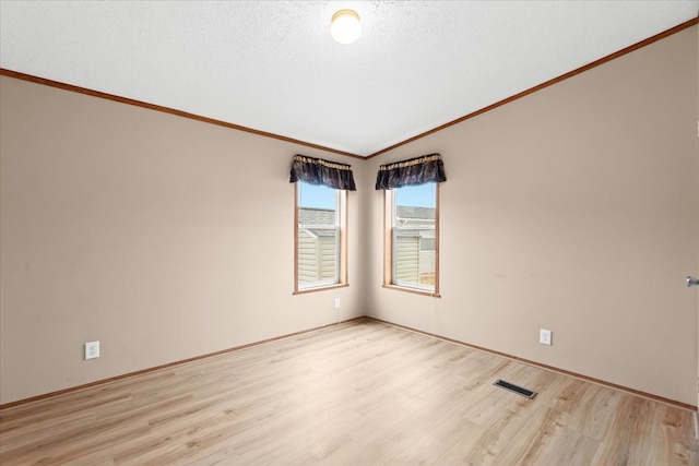 empty room with lofted ceiling and light hardwood / wood-style floors