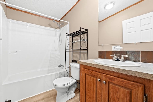 full bathroom featuring a textured ceiling, lofted ceiling, toilet, wood-type flooring, and washtub / shower combination