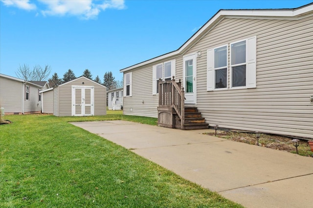 rear view of property with a patio, a yard, and a shed