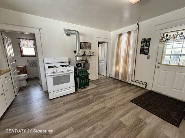 kitchen with light hardwood / wood-style flooring, white cabinetry, a wealth of natural light, and white range with gas cooktop