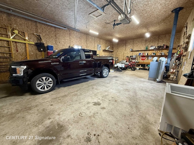 garage with a garage door opener and a workshop area