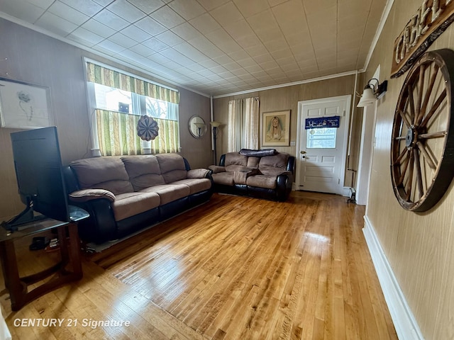 living room with crown molding and light hardwood / wood-style flooring