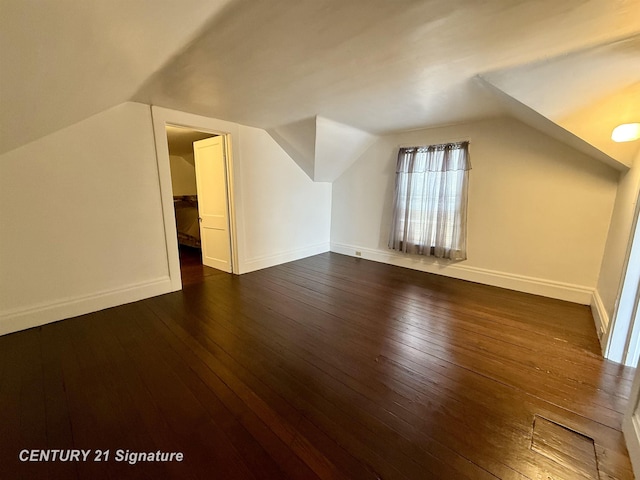 bonus room with dark hardwood / wood-style flooring and lofted ceiling