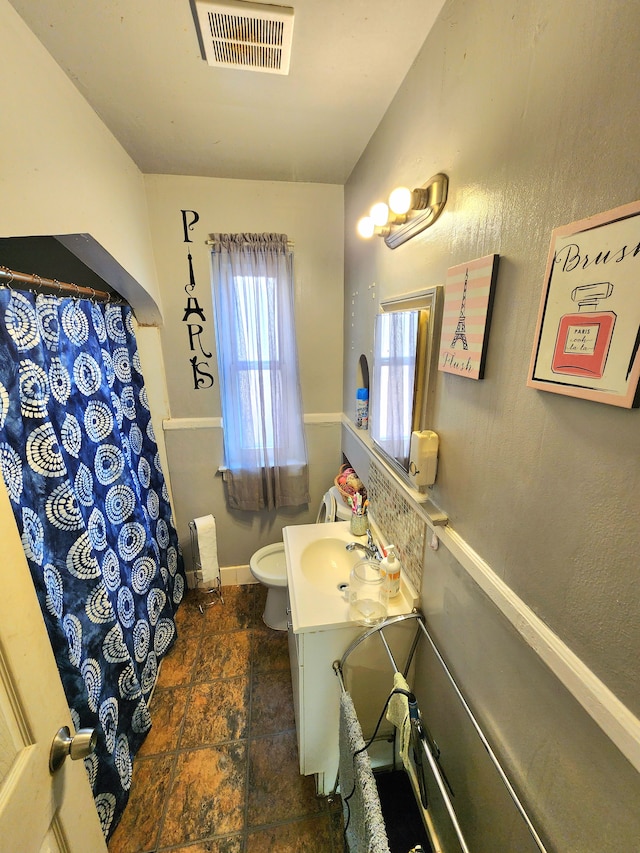 bathroom with vanity and toilet