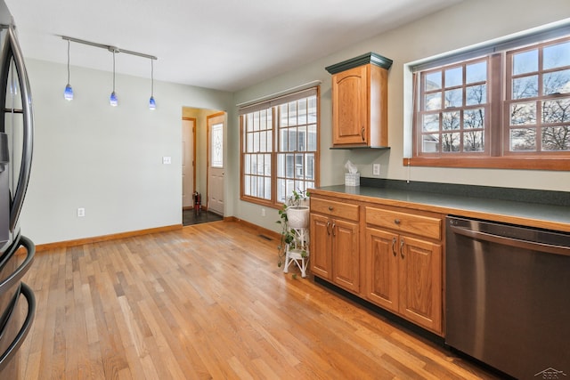 kitchen with stainless steel appliances, light hardwood / wood-style flooring, decorative light fixtures, and rail lighting