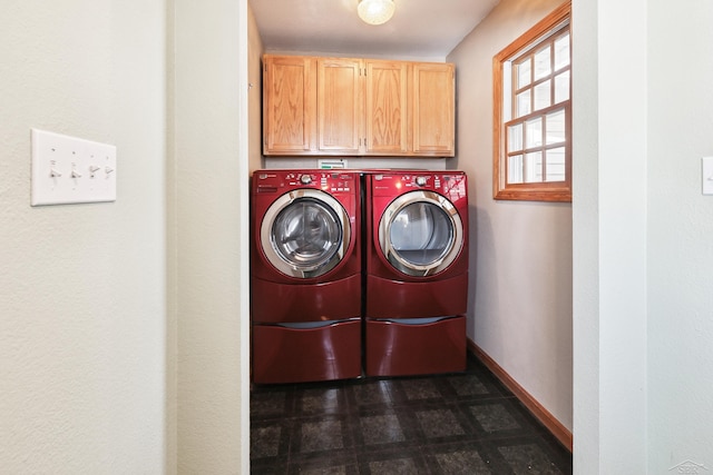 laundry area featuring washing machine and dryer and cabinets