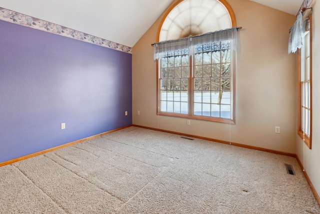 unfurnished dining area featuring vaulted ceiling and carpet