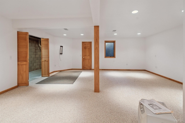 basement featuring light carpet