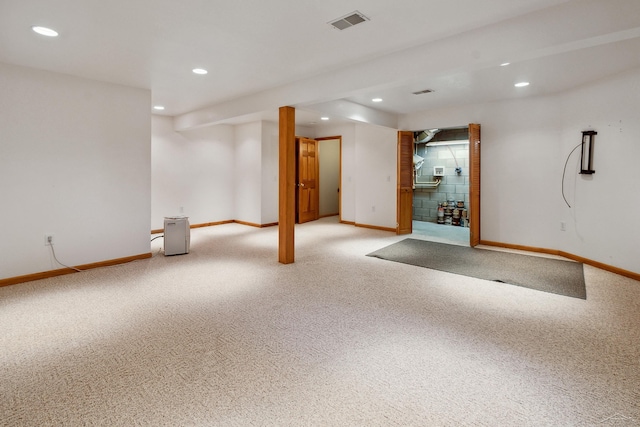 basement featuring light carpet