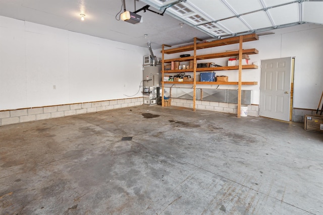 garage featuring a garage door opener and water heater