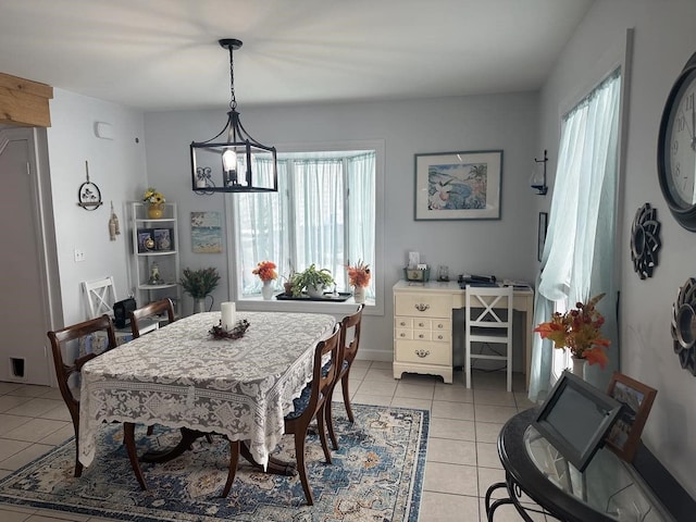 dining area with a notable chandelier, a wealth of natural light, and light tile patterned floors