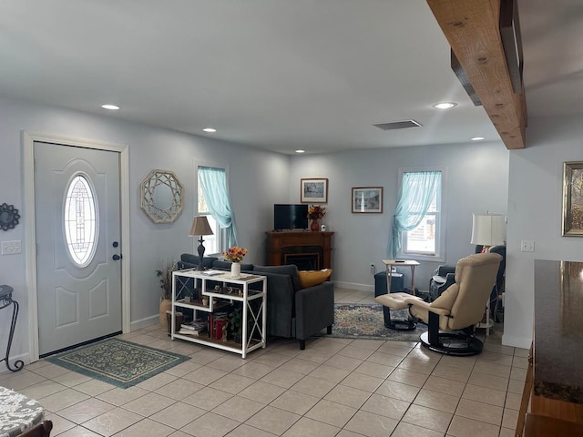 entryway with light tile patterned floors and a healthy amount of sunlight