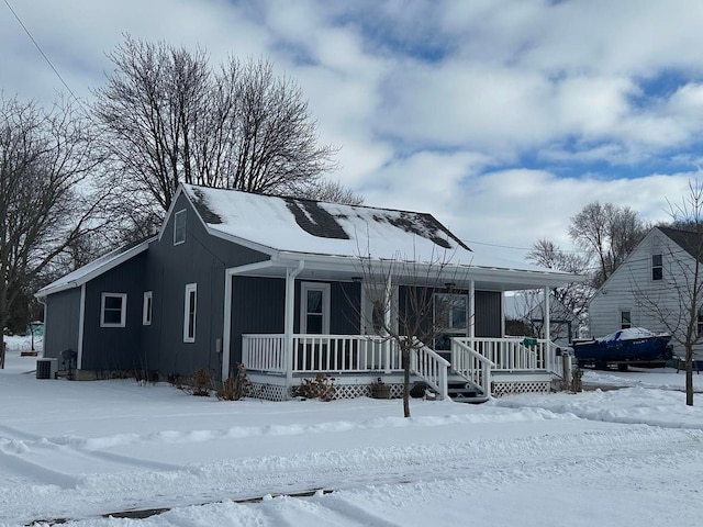 view of front of property with covered porch and central air condition unit