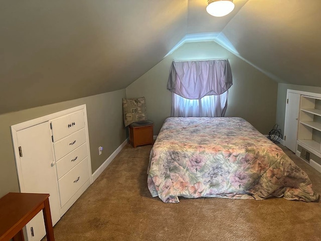 bedroom with carpet floors and vaulted ceiling