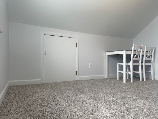 bonus room with lofted ceiling and carpet floors