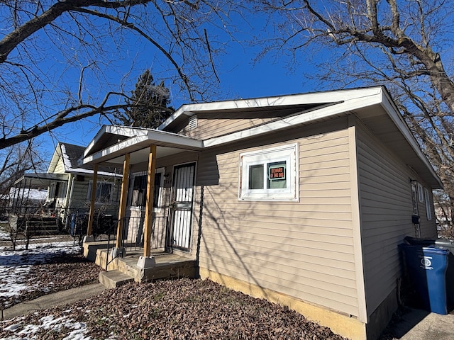 view of snowy exterior featuring a porch