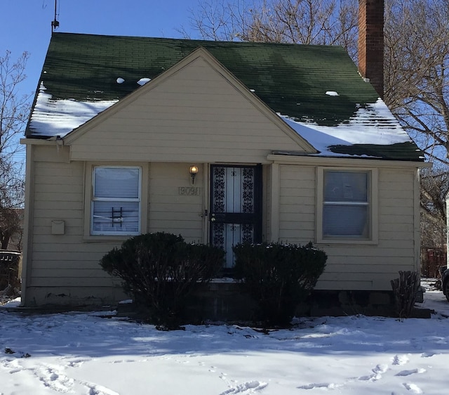 bungalow-style home with a chimney