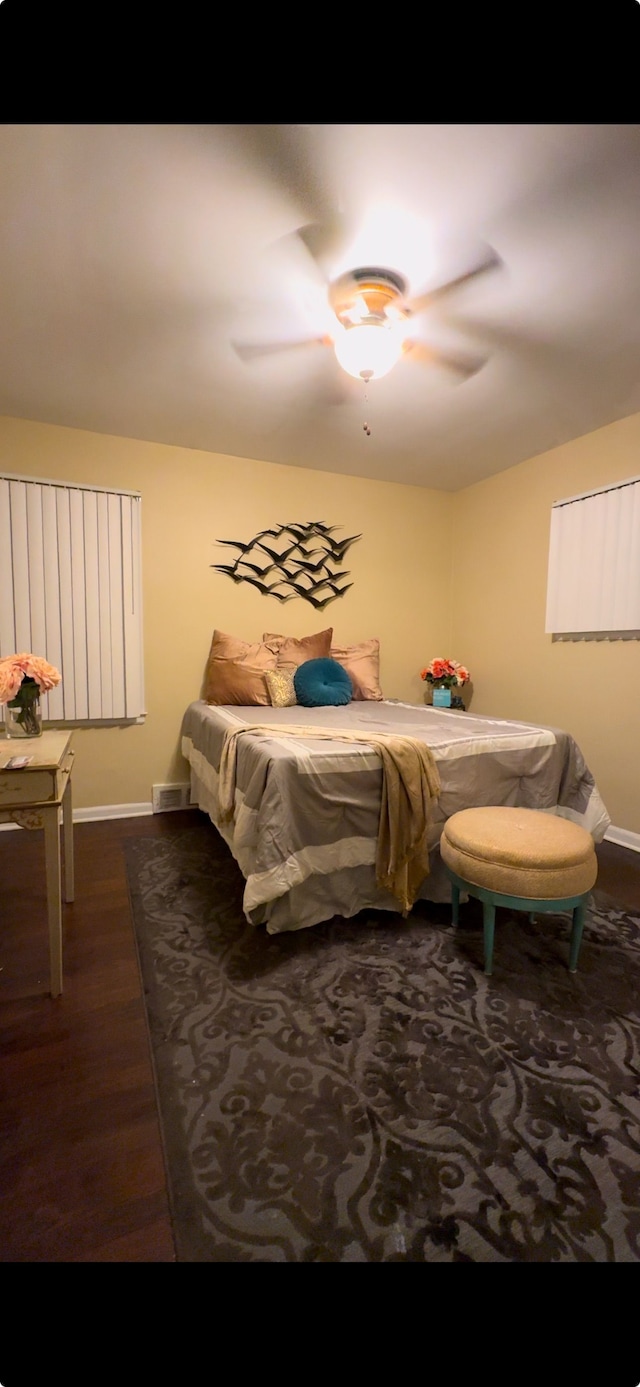 bedroom featuring ceiling fan and dark hardwood / wood-style floors