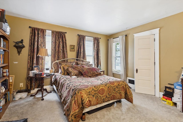 carpeted bedroom featuring multiple windows