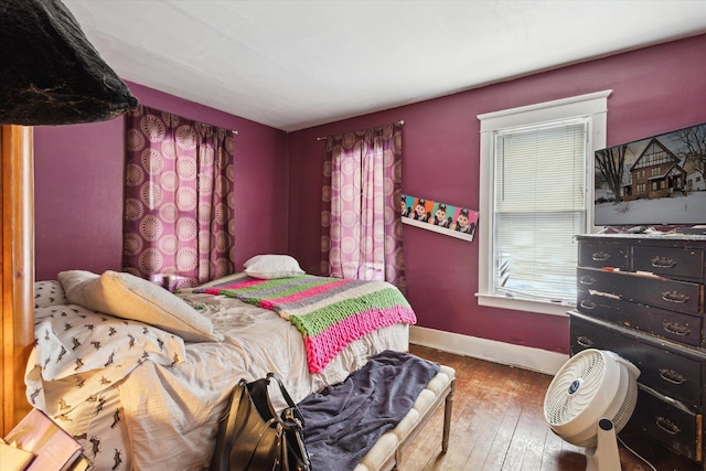 bedroom with hardwood / wood-style flooring