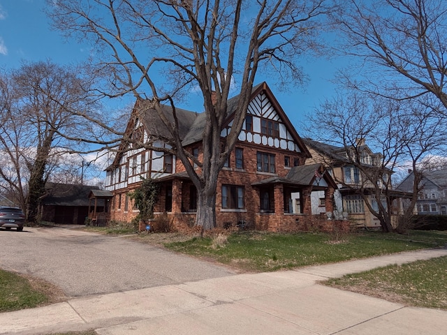 view of front of property with a front yard and brick siding