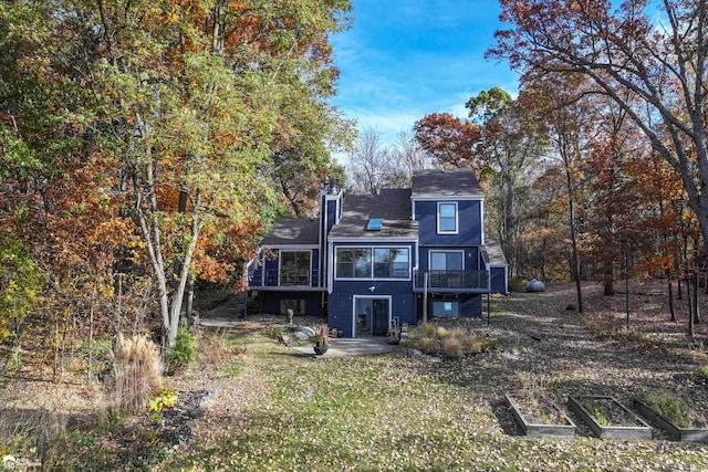 rear view of property with a wooden deck