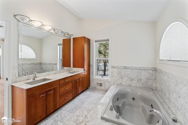 bathroom featuring vanity and a tub