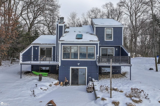 view of snow covered rear of property