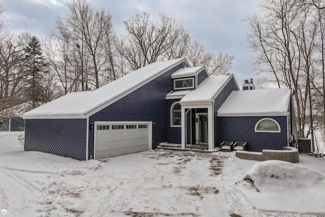 view of front property with cooling unit and a garage