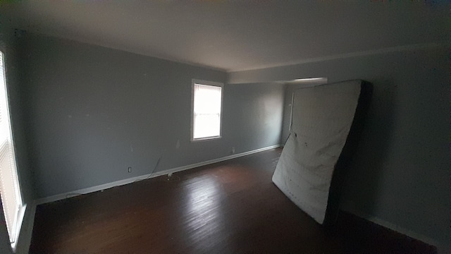 unfurnished room featuring dark hardwood / wood-style flooring