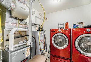 washroom with separate washer and dryer and water heater