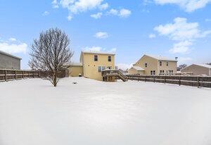 view of yard layered in snow