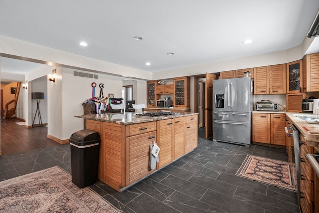 kitchen featuring appliances with stainless steel finishes and stone countertops