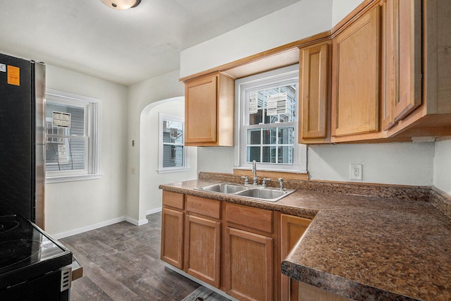 kitchen featuring sink, stainless steel fridge, dark hardwood / wood-style flooring, and black electric range