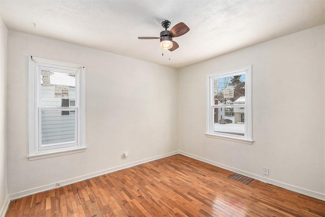 unfurnished room featuring ceiling fan and hardwood / wood-style floors