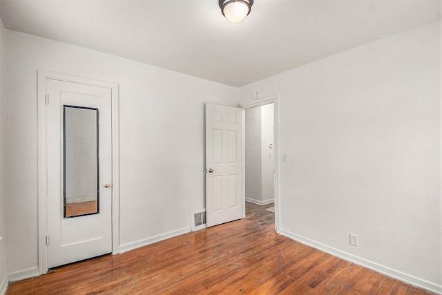 spare room with hardwood / wood-style floors