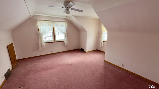 additional living space with ceiling fan, light colored carpet, and lofted ceiling