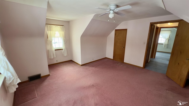 bonus room featuring ceiling fan, lofted ceiling, a wealth of natural light, and carpet flooring