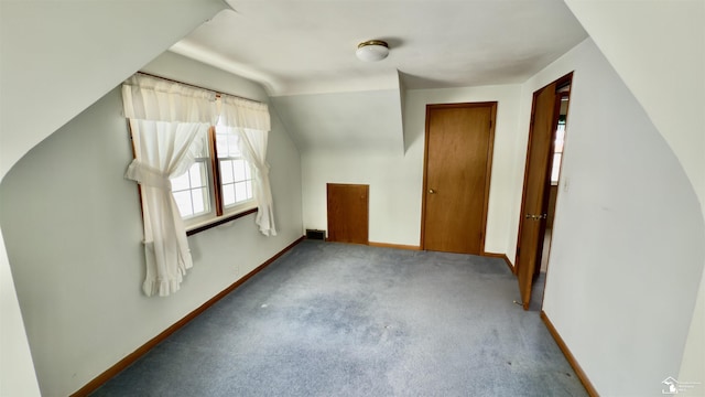 additional living space with lofted ceiling and carpet