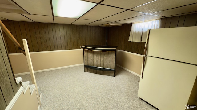 unfurnished room featuring a paneled ceiling and carpet flooring