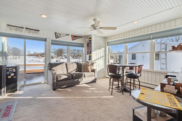 sunroom featuring ceiling fan