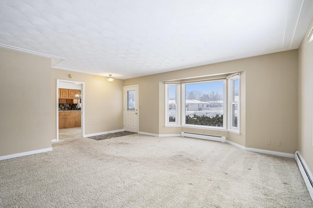 empty room with baseboard heating and light carpet