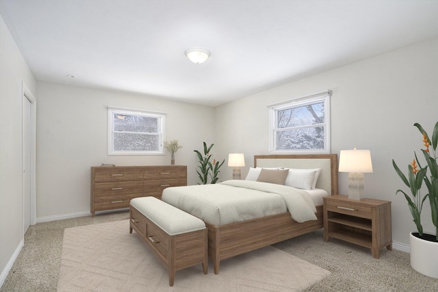 bedroom featuring multiple windows and light carpet